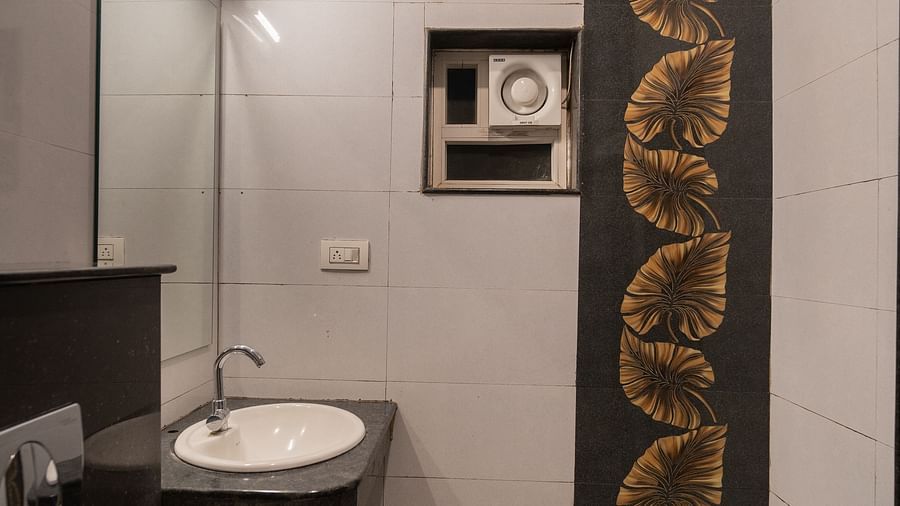 Image of a washroom with a sink and a toilet at Parampara Resort & Spa, Kushalnagar.